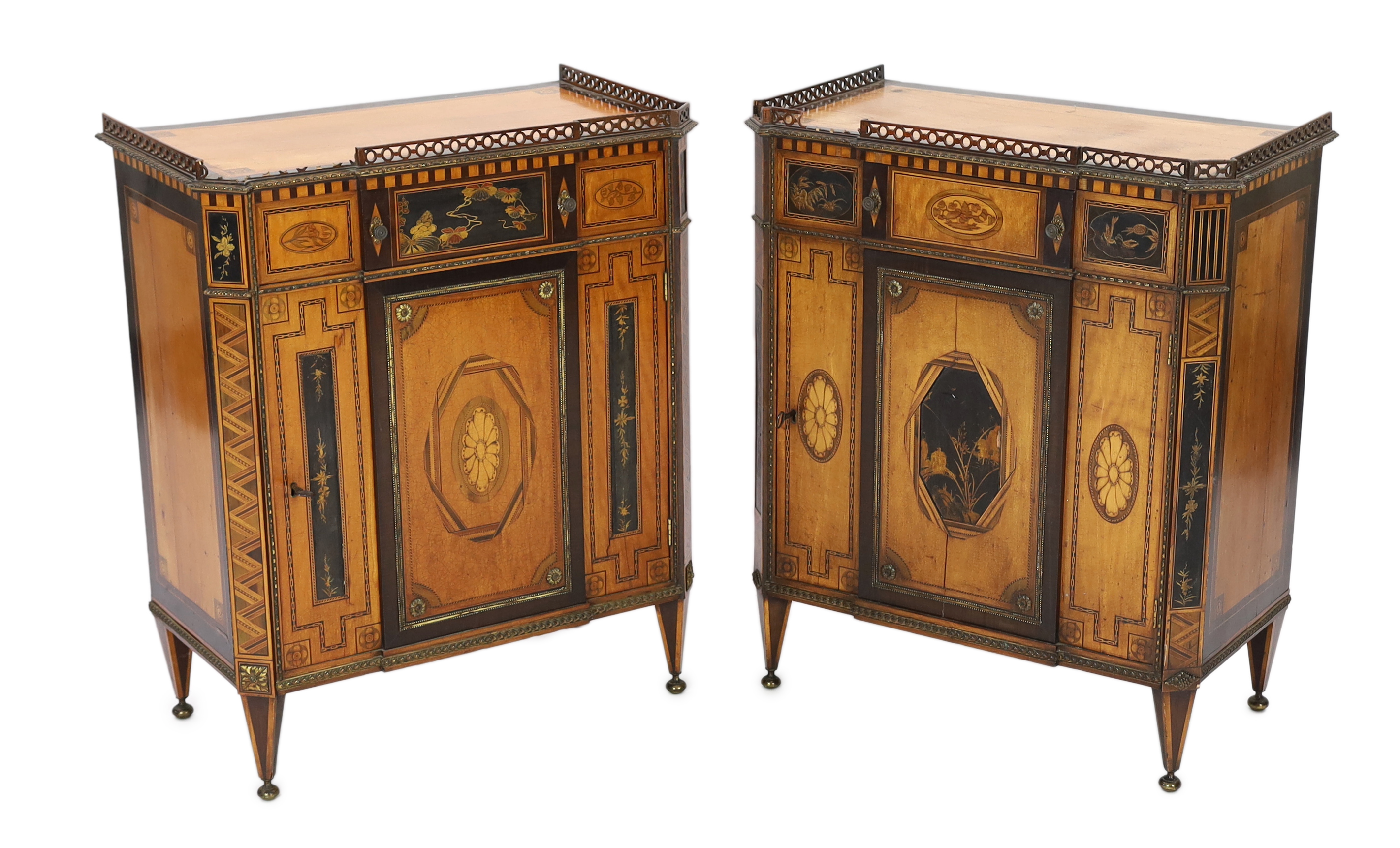 A pair of French Transitional style satinwood and marquetry side cabinets, 57cm wide, 40cm deep, 87cm high